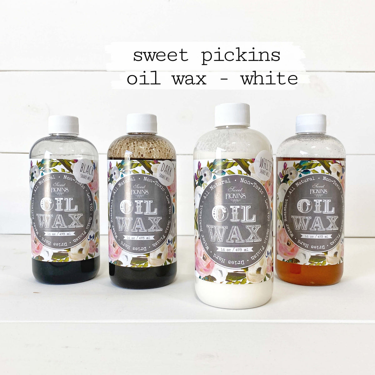 Four bottles of 'sweet pickings oil wax - white' on a white background