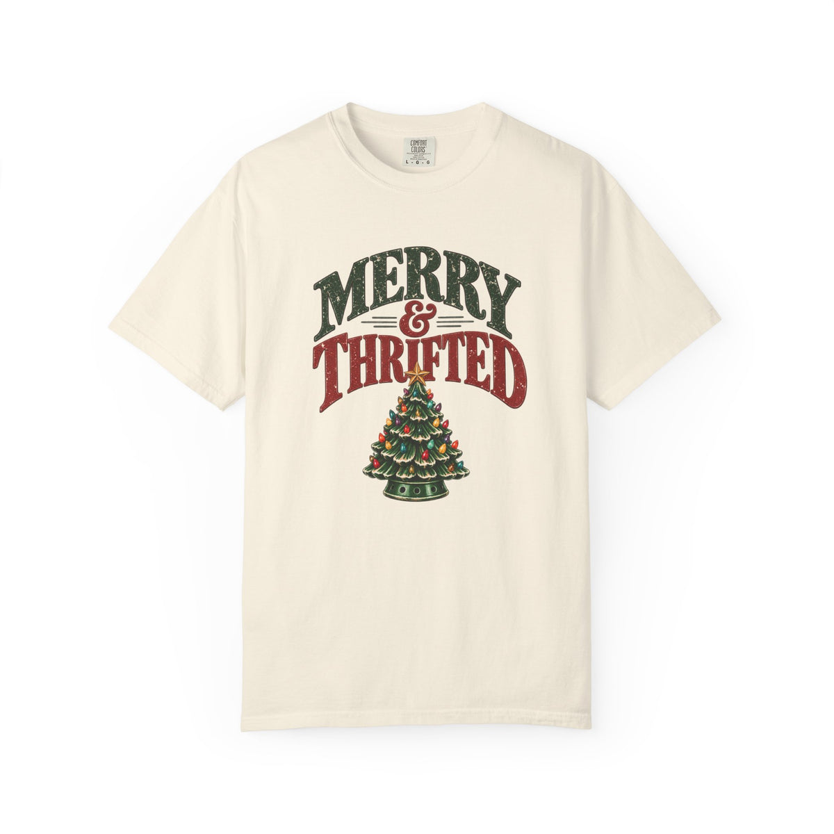 An off-white short-sleeve crewneck t-shirt featuring a distressed graphic on the front that reads 'MERRY & THRIFTED' above a Christmas tree made of cash registers.