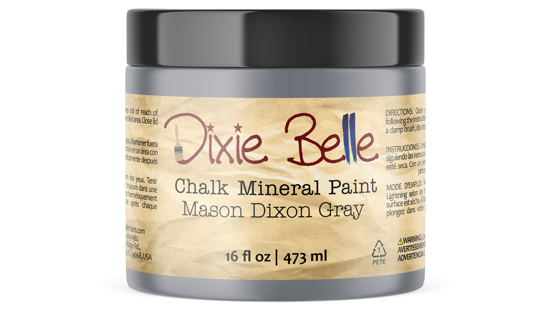 A jar of Dixie Belle Chalk Mineral Paint in the Mason Dixon Gray colorway, featuring a textured beige label and a dark gray lid on a white background.
