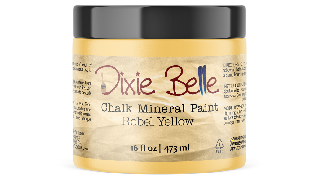 A 16 fl oz jar of Dixie Belle Chalk Mineral Paint in the color Rebel Yellow, featuring a black lid and a textured tan paper label.