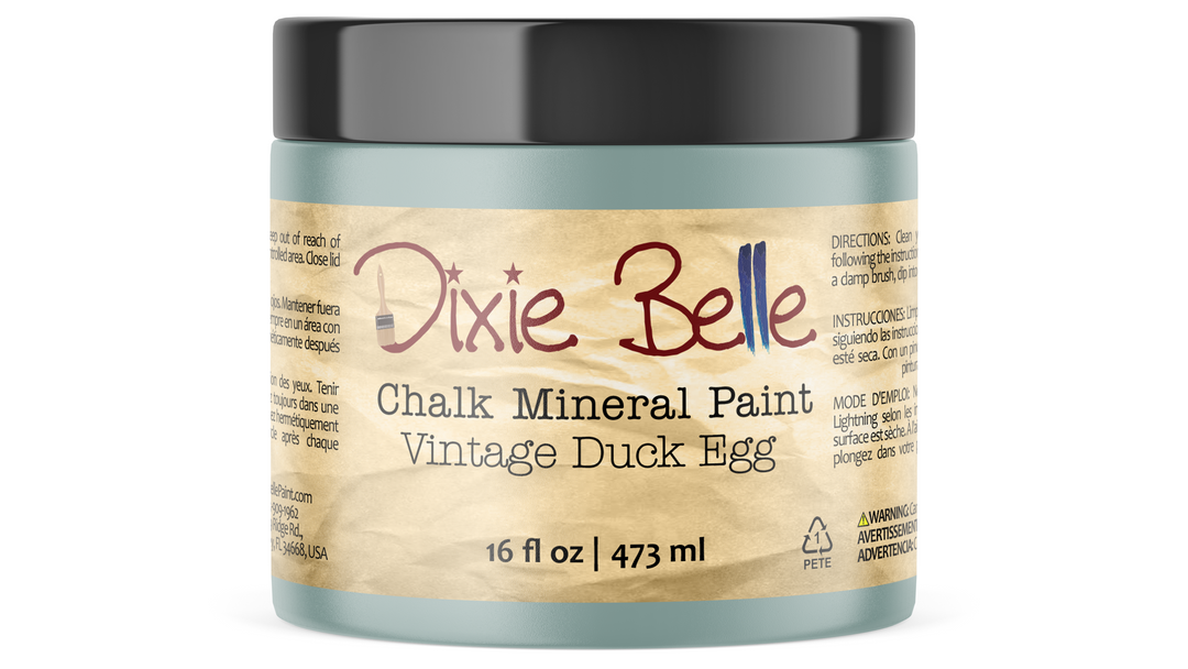 A jar of Dixie Belle Chalk Mineral Paint in the Vintage Duck Egg color, featuring a black lid and a beige label with red and black text.