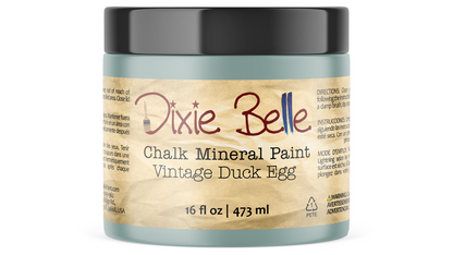 A jar of Dixie Belle Chalk Mineral Paint in the Vintage Duck Egg color, featuring a black lid and a beige label with red and black text.