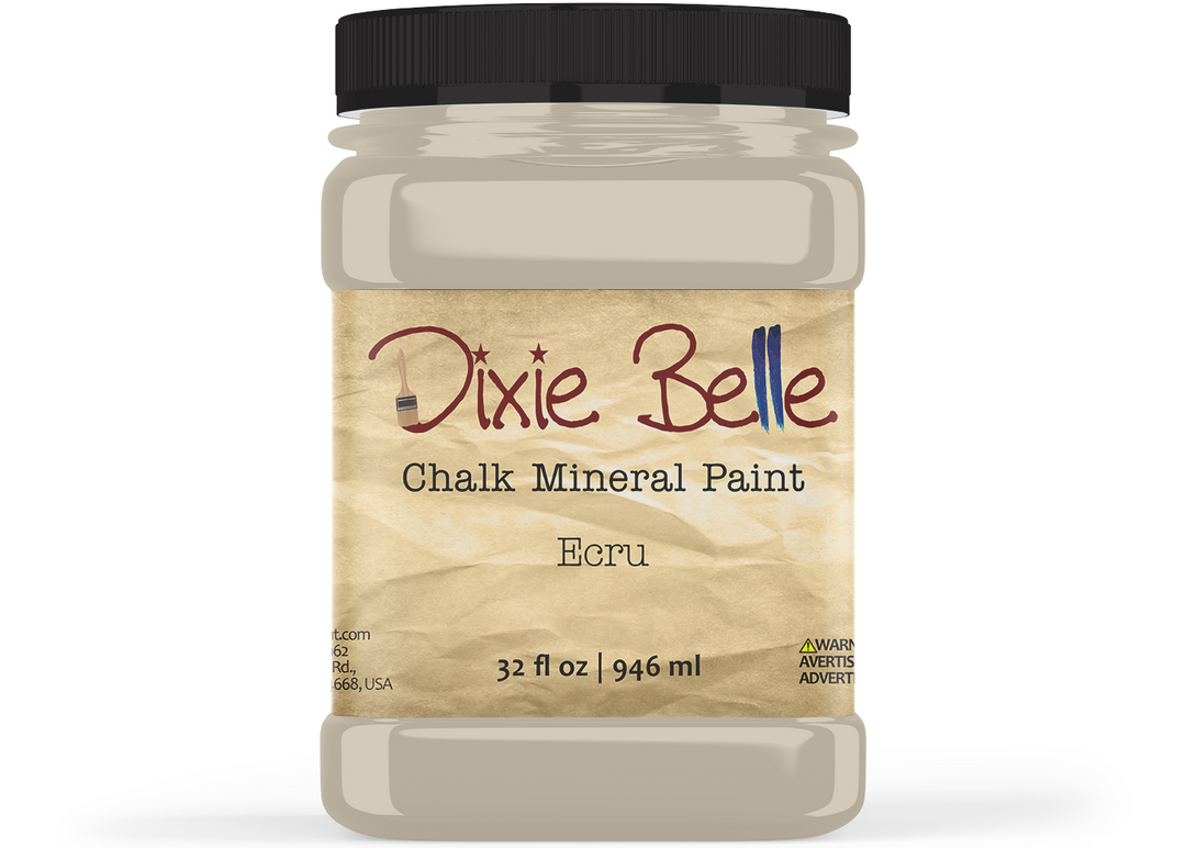 A jar of Dixie Belle Chalk Mineral Paint in the color Ecru, featuring a black screw cap and a textured beige label, shown against a plain white background.