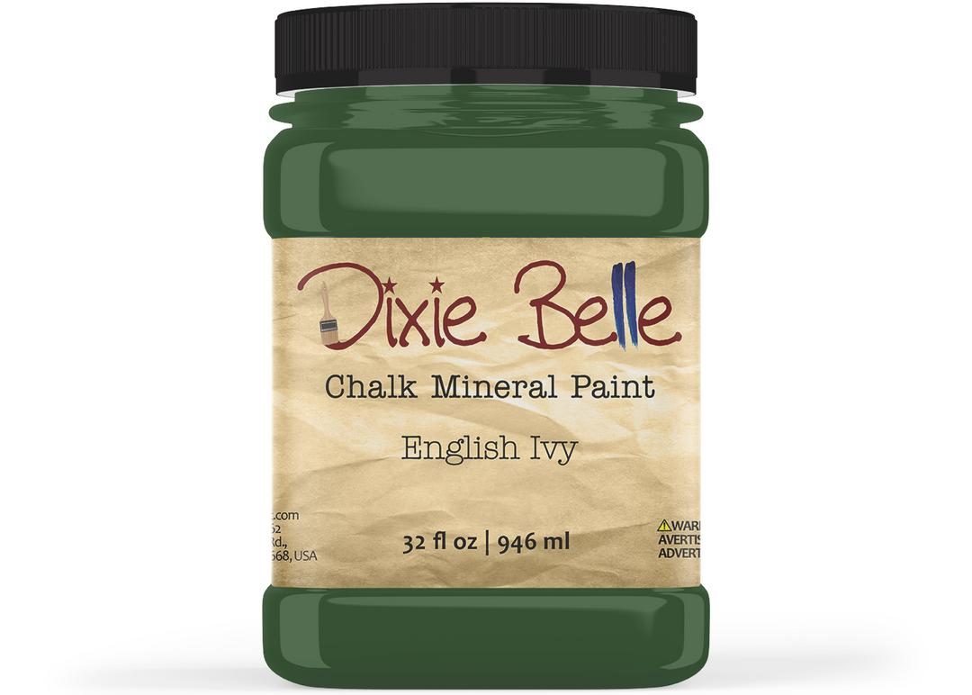A jar of Dixie Belle Chalk Mineral Paint in the color English Ivy, featuring a dark green paint jar with a black lid and a beige textured label.