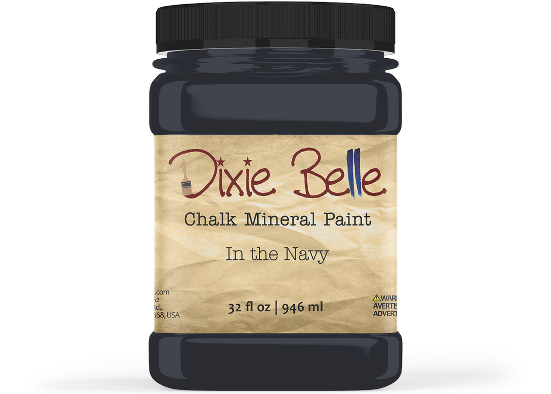 A jar of Dixie Belle Chalk Mineral Paint in the color Navy, featuring a black lid and a beige textured label on a white background.