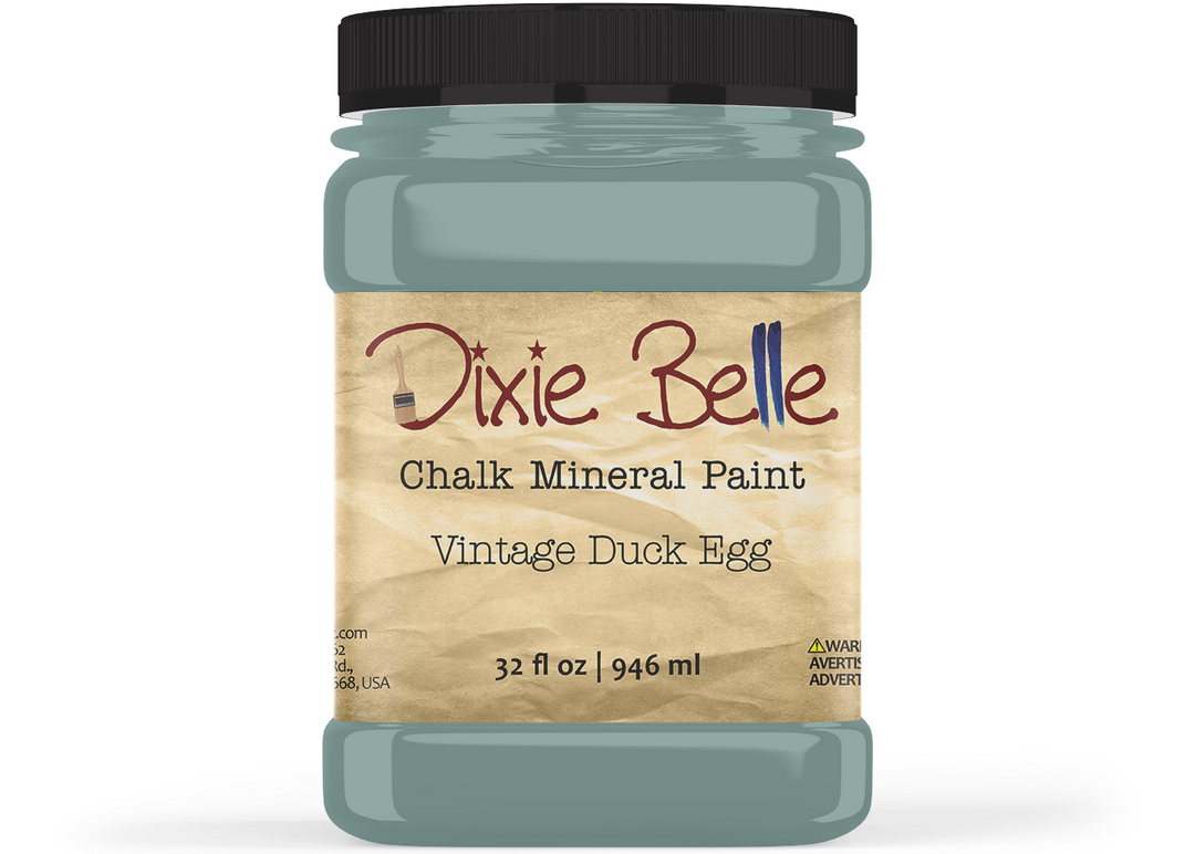 A jar of Dixie Belle Chalk Mineral Paint in the shade 'Vintage Duck Egg', featuring a black lid and a beige label with brown and black text, set against a plain white background.