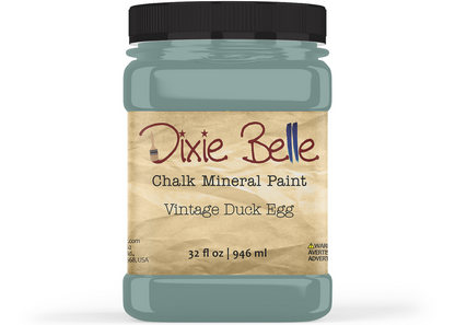 A jar of Dixie Belle Chalk Mineral Paint in the shade 'Vintage Duck Egg', featuring a black lid and a beige label with brown and black text, set against a plain white background.