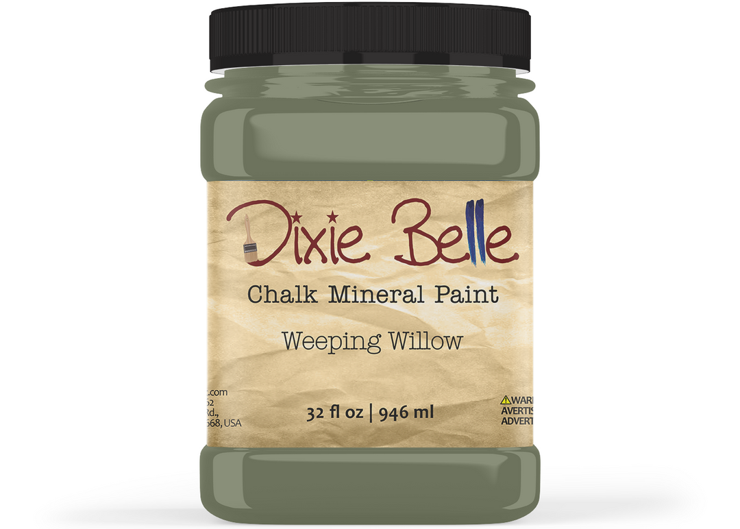 A jar of Dixie Belle Chalk Mineral Paint in the shade Weeping Willow, featuring a black lid and a beige label with brown and blue lettering.