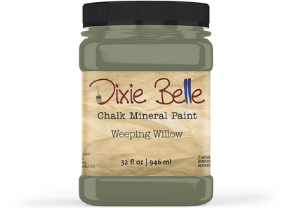 A jar of Dixie Belle Chalk Mineral Paint in the shade Weeping Willow, featuring a black lid and a beige label with brown and blue lettering.
