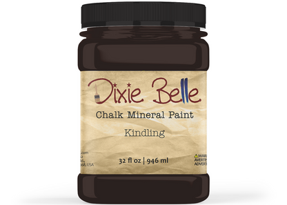 A jar of Dixie Belle Chalk Mineral Paint in the color 'Kindling', featuring a black plastic jar and a textured beige label with brown and blue lettering.