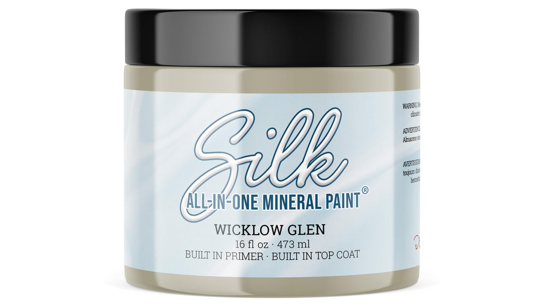 A 16oz. jar of Silk All-In-One Mineral Paint in the color Wicklow Glen, featuring a light blue and white label with a black lid, on a white background.