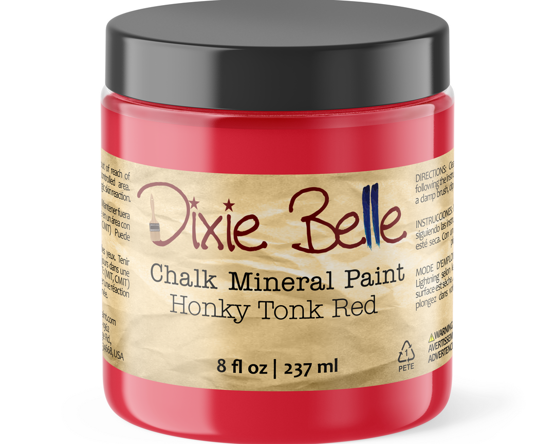 A jar of Dixie Belle Chalk Mineral Paint in the color Honky Tonk Red, featuring a black lid and a tan paper label on a white background.
