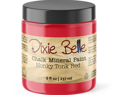 A jar of Dixie Belle Chalk Mineral Paint in the color Honky Tonk Red, featuring a black lid and a tan paper label on a white background.
