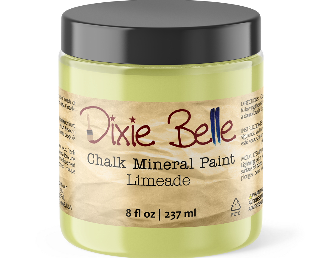 A jar of Dixie Belle Chalk Mineral Paint in the shade Limeade, featuring a black lid and a beige label with brown and blue text.