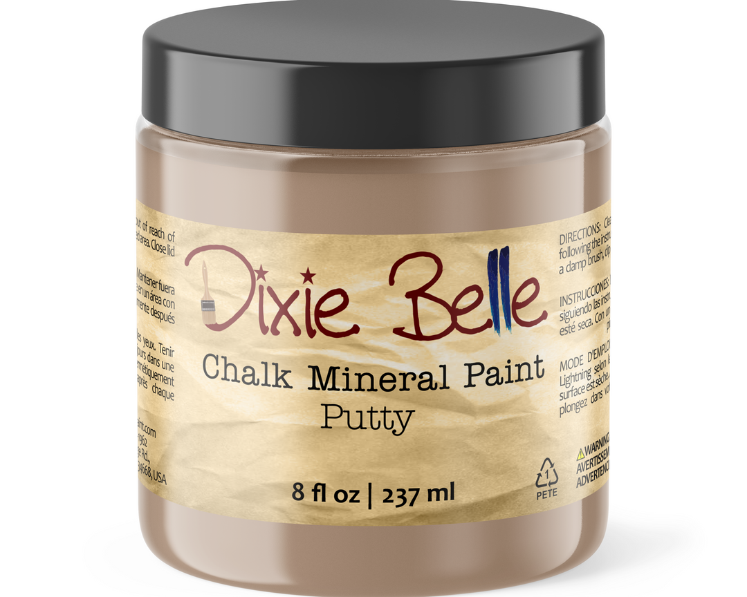 A jar of Dixie Belle Chalk Mineral Paint Putty, 8 fl oz, featuring a black lid and a beige label with brown and red lettering, set against a plain white background.