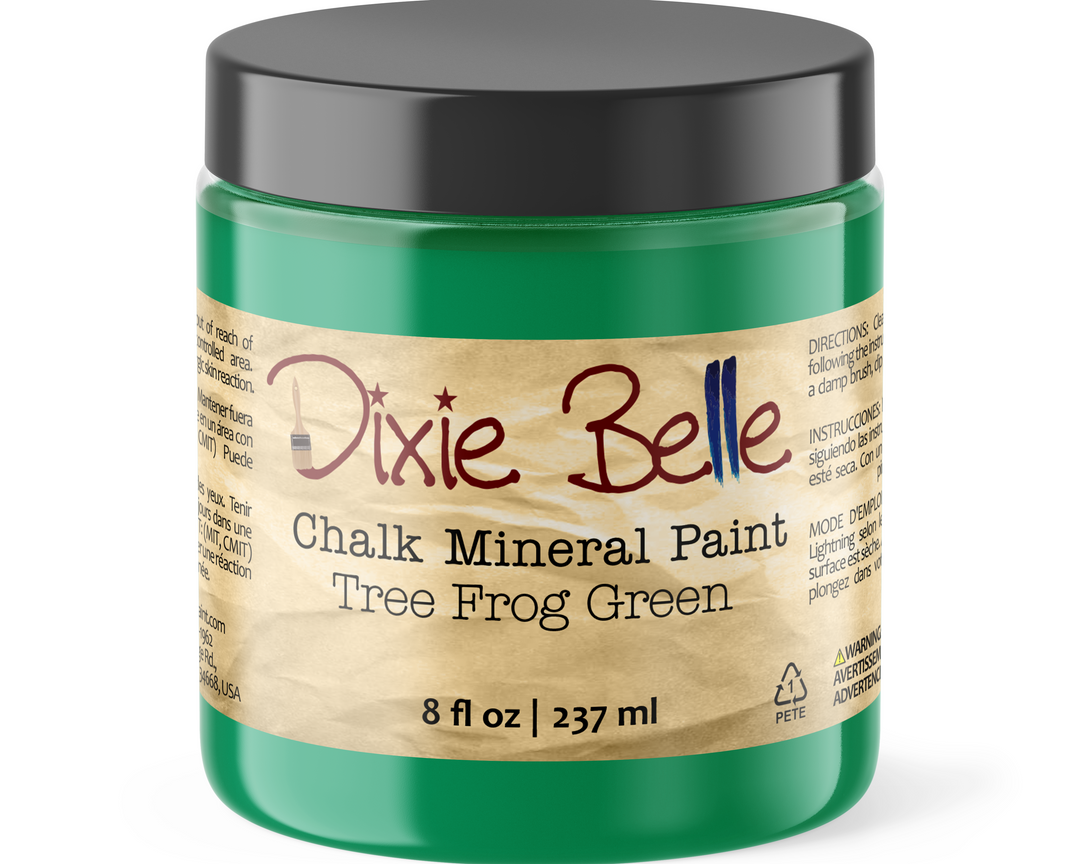 Green jar of Dixie Belle Chalk Mineral Paint Tree Frog Green with a black lid on a white background