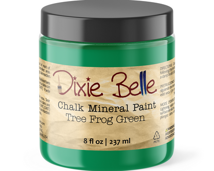 Green jar of Dixie Belle Chalk Mineral Paint Tree Frog Green with a black lid on a white background