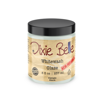 A jar of Dixie Belle Whitewash Glaze, 8 fl oz, featuring a black lid and a beige parchment-style label with red and black text, set against a plain white background.