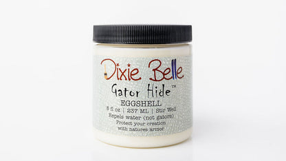 A white plastic jar of Dixie Belle Gator Hide Eggshell adhesive with a black ribbed screw cap, shown against a plain white background.