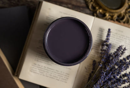 Hearth black paint jar on an open book with lavender flowers