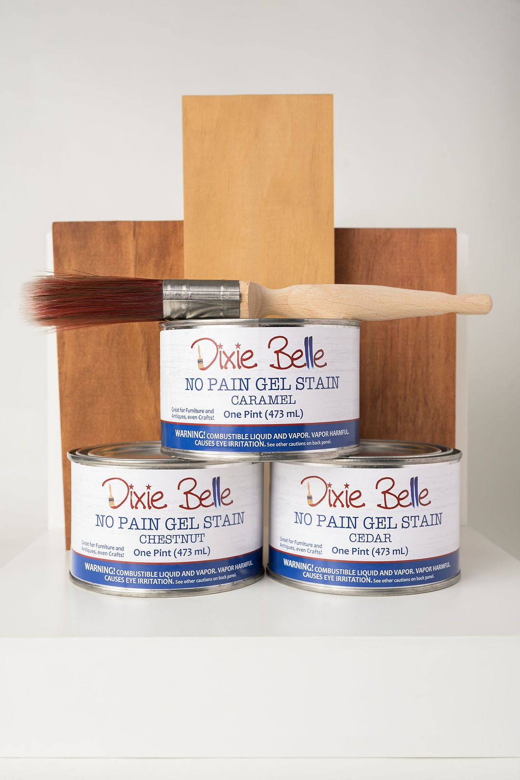 Dixie Belle gel stain with wooden boards and a brush on a white background