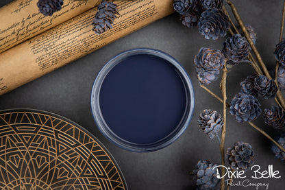 Color In The Navy paint container with decorative elements on a dark surface, featuring the Dixie Belle Paint Company logo.