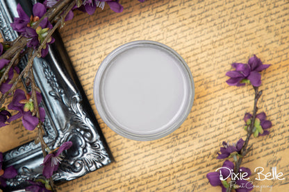 Dixie Belle Paint color Mason Dixon Gray on a textured surface with purple flowers
