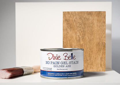 Can of Dixie Belle No Pain Gel Stain with a sample swatch on wood and a brush.