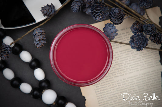 Dixie Belle Paint Plum Crazy on a surface with decorative elements and 'Dixie Belle' branding.
