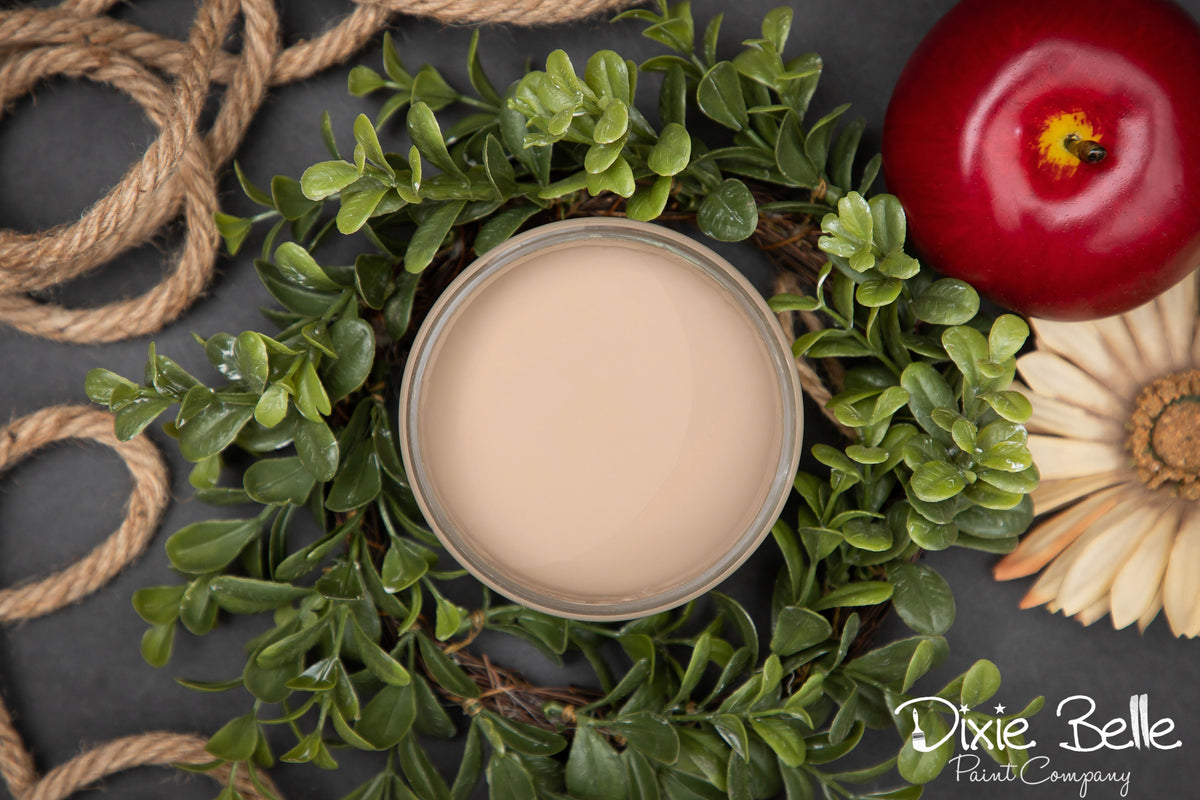 Dixie Belle Paint Color Putty container on a decorative wreath with a red tomato and sunflower, featuring the Dixie Belle Paint Company logo.