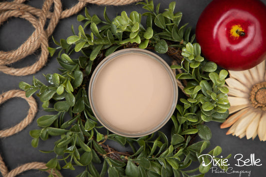 Dixie Belle Paint Color Putty container on a decorative wreath with a red tomato and sunflower, featuring the Dixie Belle Paint Company logo.