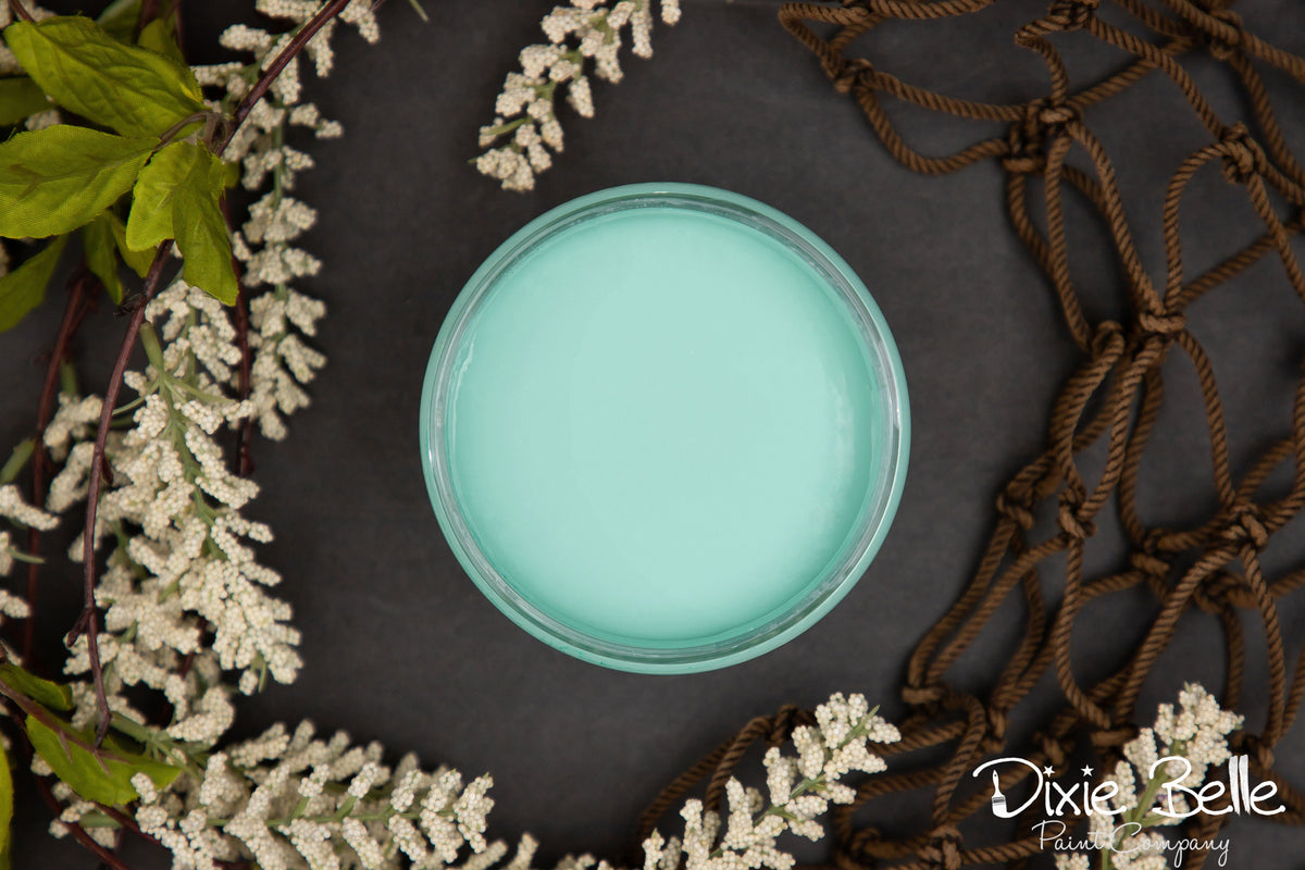 Dixie Belle Paint color The Gulf on a dark surface with decorative elements