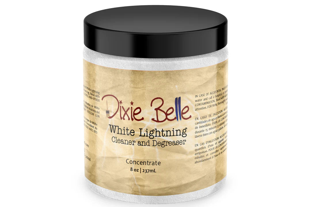 A jar of Dixie Belle White Lightning Cleaner and Degreaser concentrate, featuring a black lid and a beige textured label, set against a plain white background.