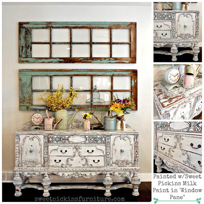 Decorative sideboard with distressed finish and floral arrangements, surrounded by similar furniture pieces.
