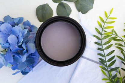 Terra Clay Paint Wistera on a white surface with blue flowers and green leaves.