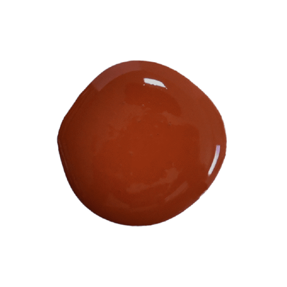 a drop of cherry pie milk paint on a white background