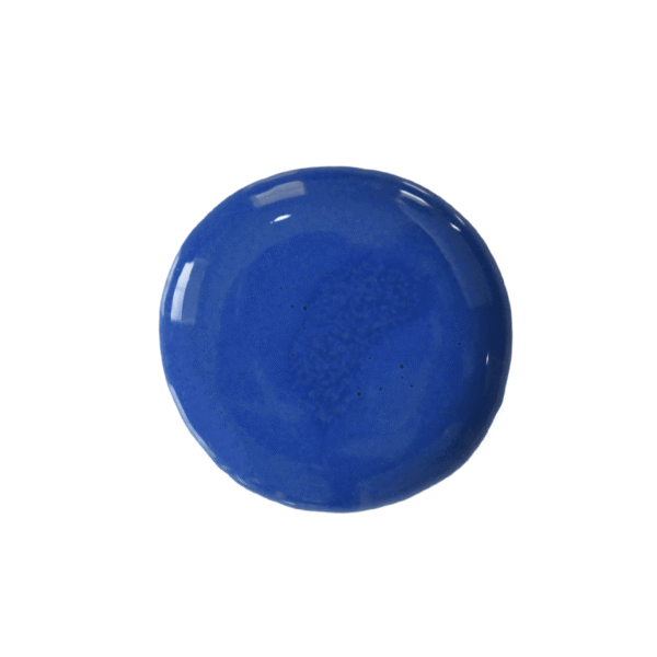 Drop of cobalt milk paint on a white background