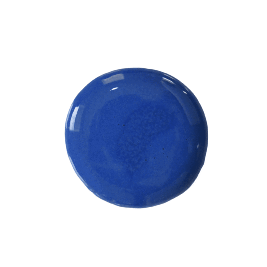 Drop of cobalt milk paint on a white background