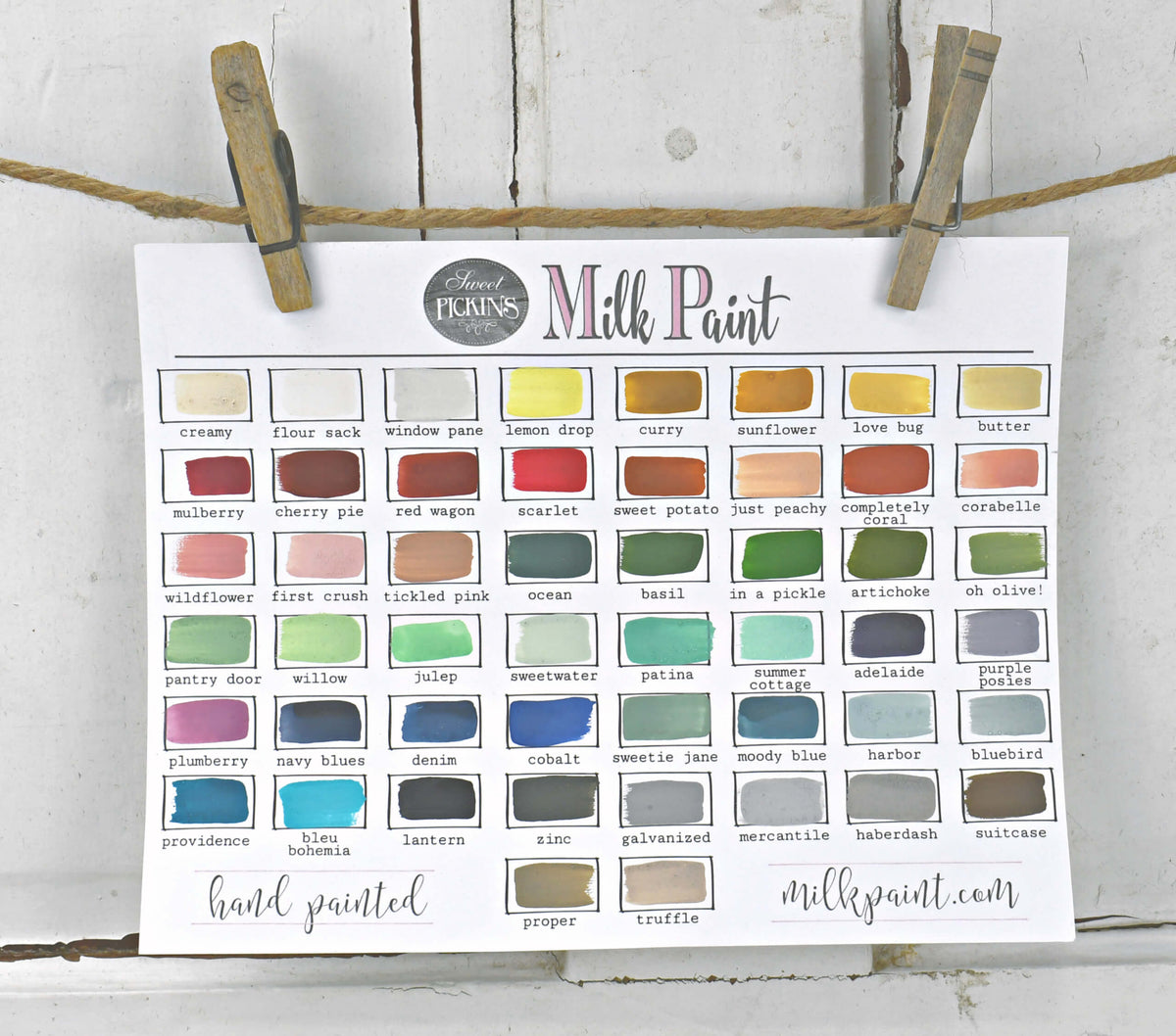Color swatch chart for milk paint hanging on a line with clothespins.