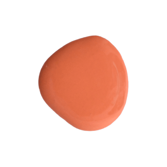 a drop of completely coral milk paint on a solid white background.