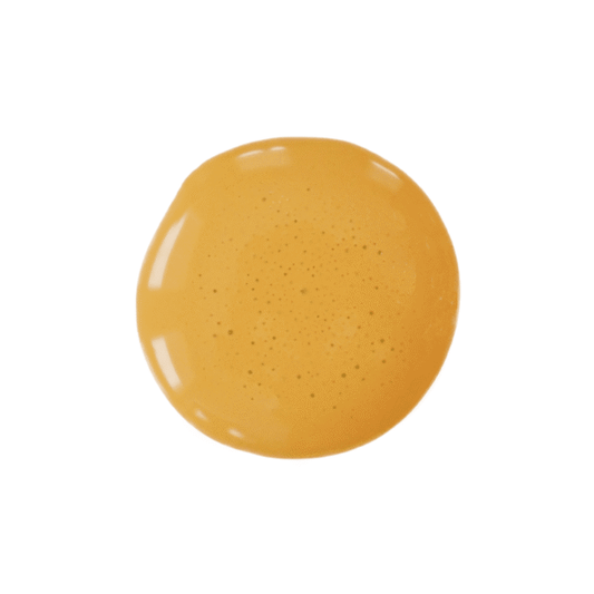 a drop of curry milk paint on a solid white background