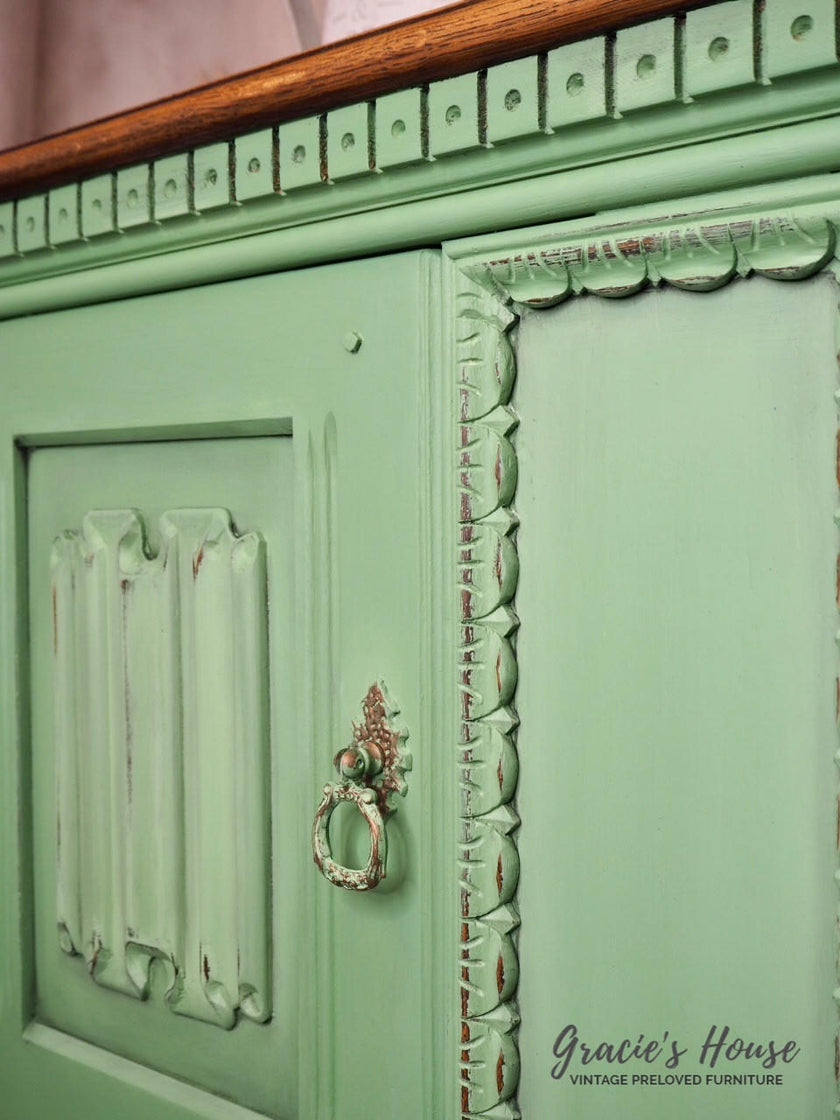 Vintage green cabinet with decorative details and a small handle, featuring 'Gracie's House' branding.