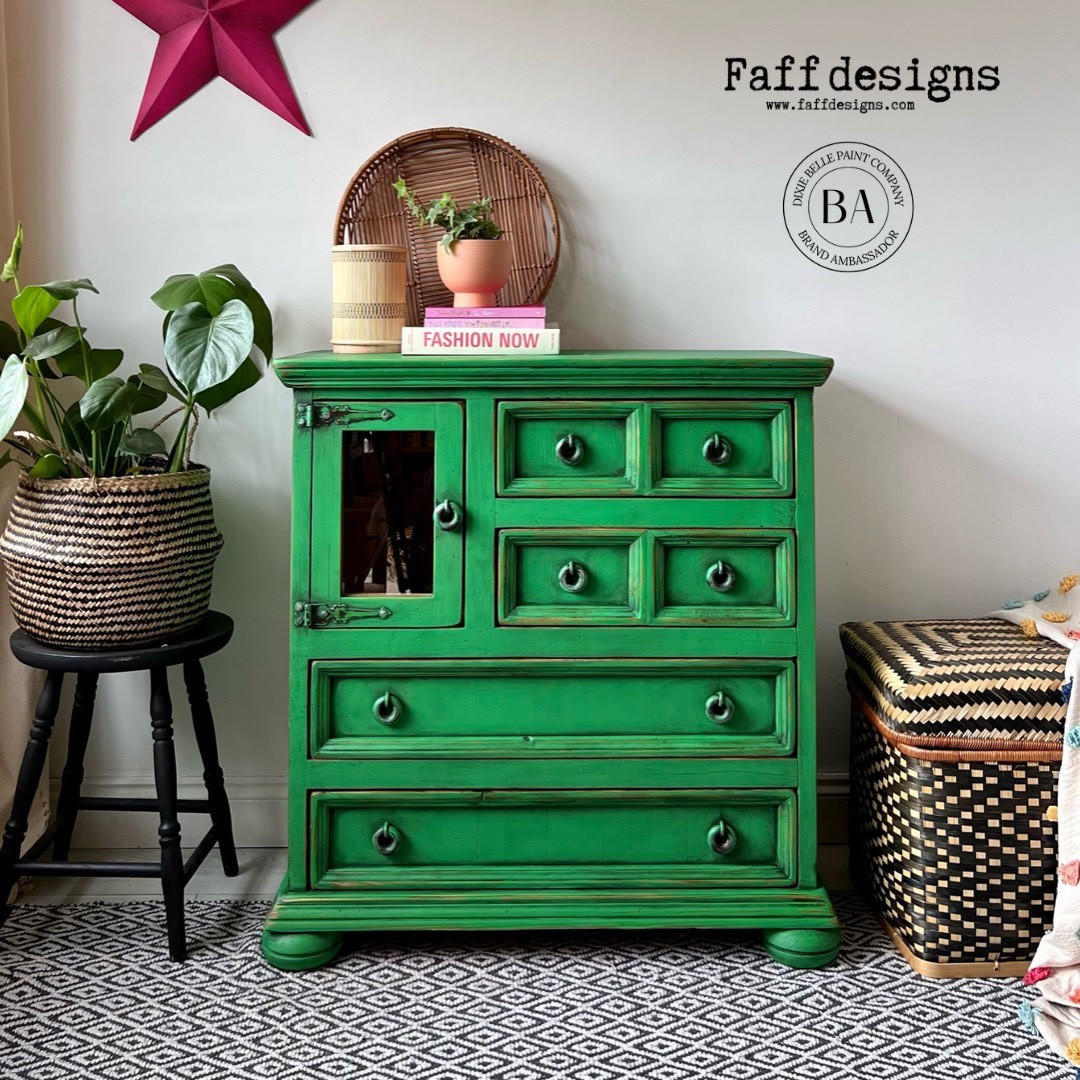 A bright green painted wooden chest of drawers with distressed detailing, shown in a styled room setting with a potted plant on a stool, a basket, and patterned rug. The image includes 'Faff designs' branding and a circular BA logo watermark.
