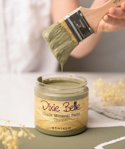 Dixie Belle Chalk Mineral Paint jar with a brush applying paint