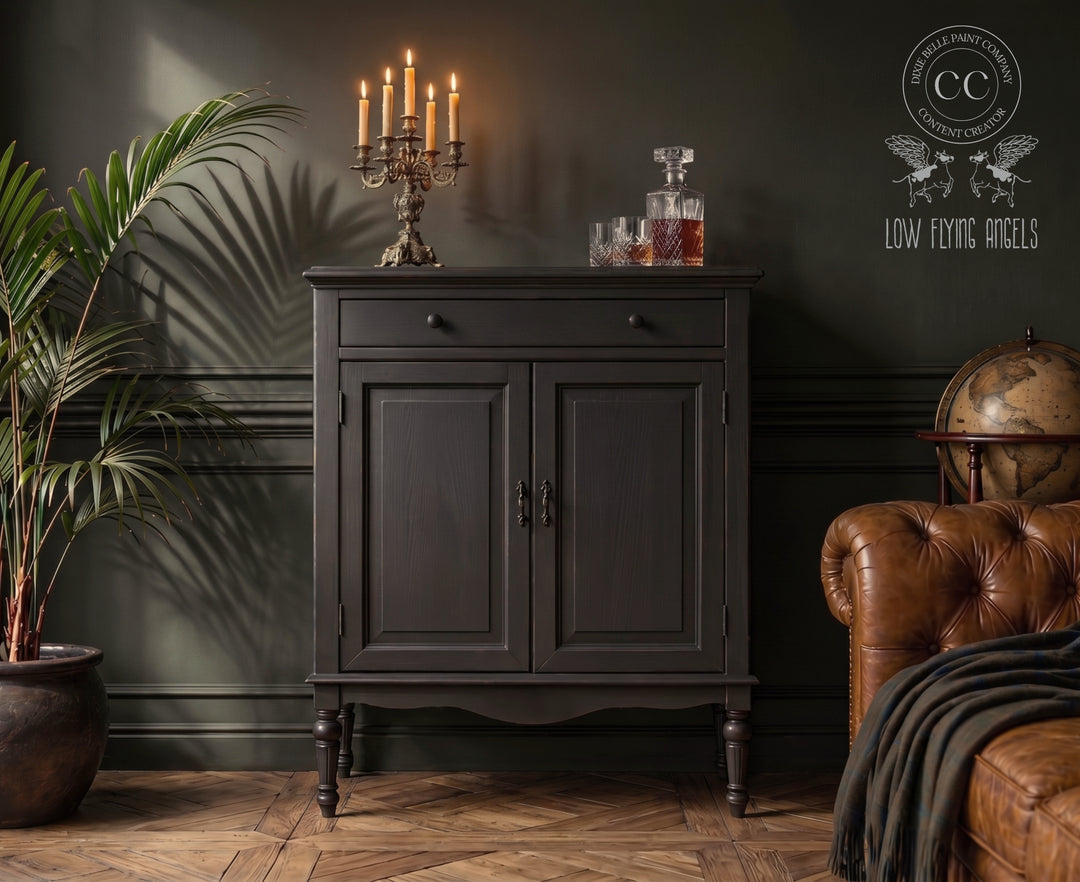Dark wooden cabinet in a room with a leather sofa, potted plant, and decorative items.