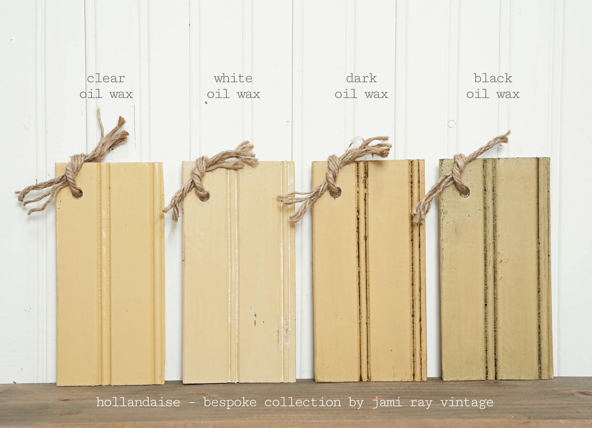 Four wooden boards with different oil wax finishes on a white wooden background.
