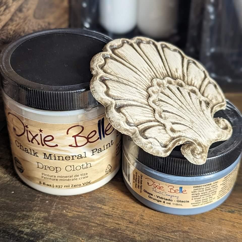 Two jars of Dixie Belle Chalk Mineral Paint on a wooden surface
