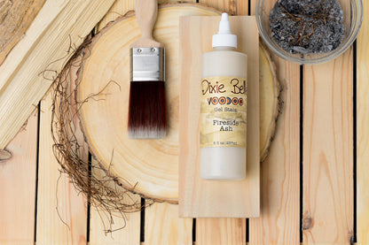 Dixie Belle Fireside Ash wood stain with brush and container on wooden surface