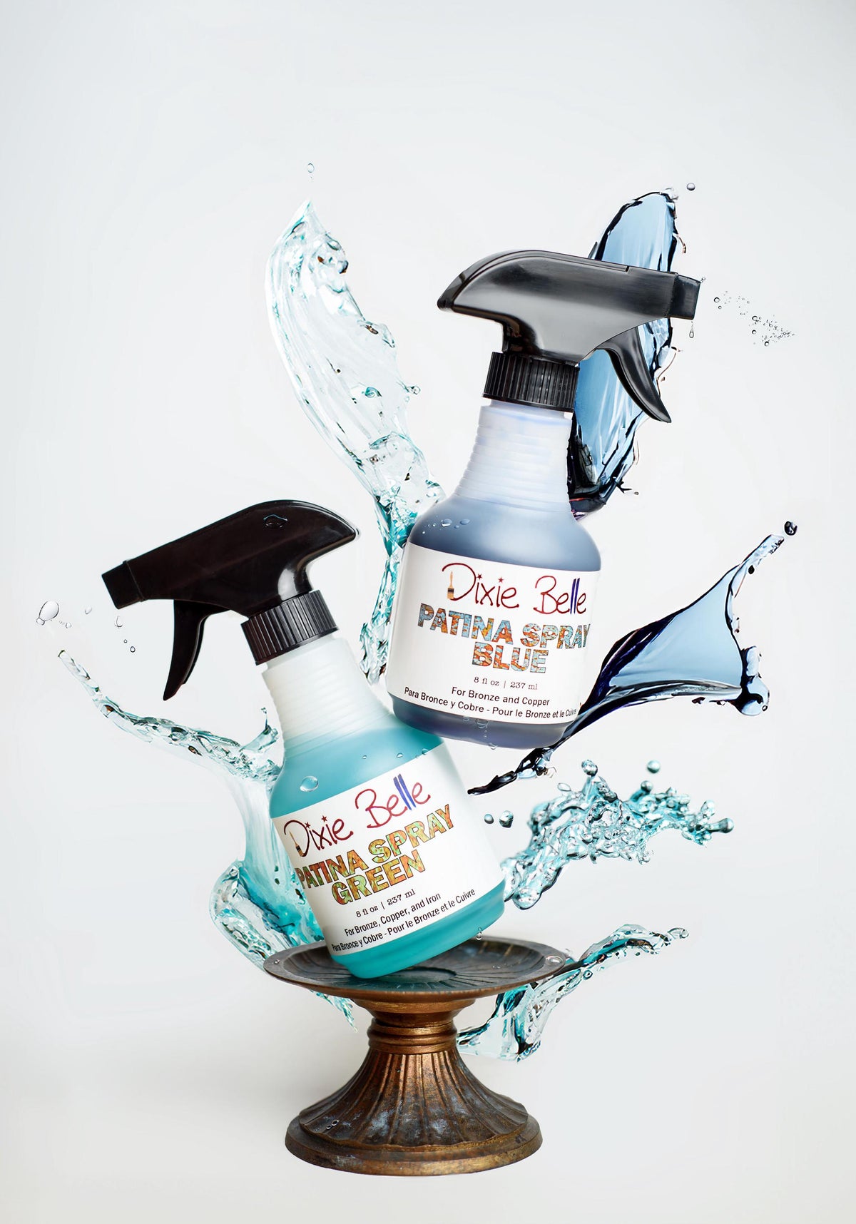 Two bottles of Dixie Belle Paint with water splashes on a white background