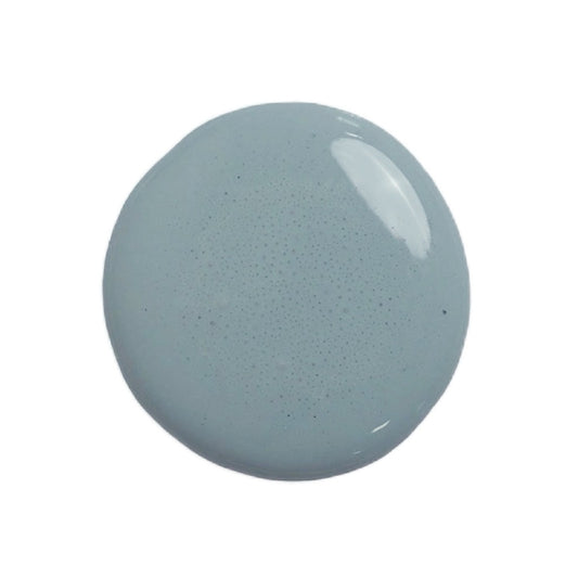 a drop of kent milk paint on a white background